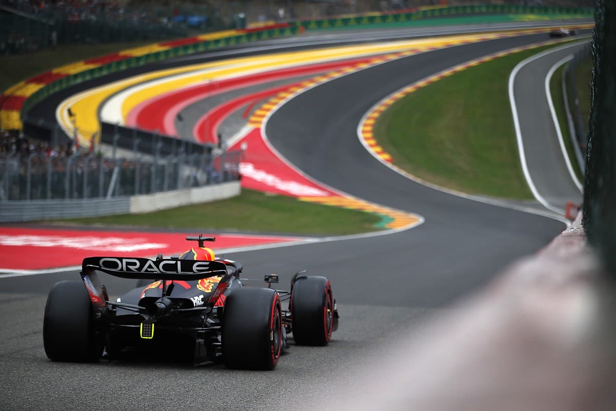 A Red Bull Racing car seen from behind, heading towards Eau Rouge at Spa-Francorchamps